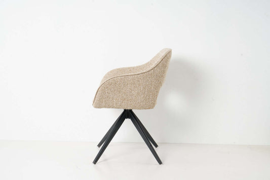 Side view of the Jordan dining chair by VSO Design, featuring soft woven upholstery and stylish wooden legs.